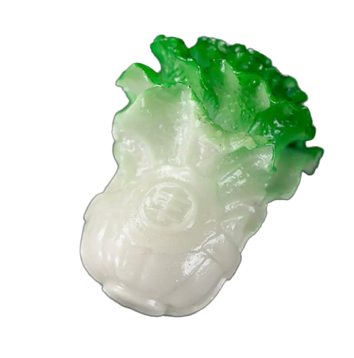 A carved jadeite-like cabbage tea pet, with a glossy white base and vibrant green leafy top, isolated on a white background.