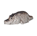 A realistic crocodile tea pet named 'Crodie' with textured scales, shown in profile against a plain white background.