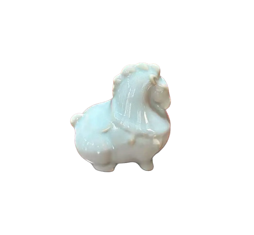 A small glossy ceramic figurine of a blue horse tea pet, decorated with a pale celadon glaze, isolated on a solid white background.