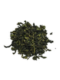 A small pile of Iron goddess of mercy Oolong loose-leaf green tea leaves on a plain white background.