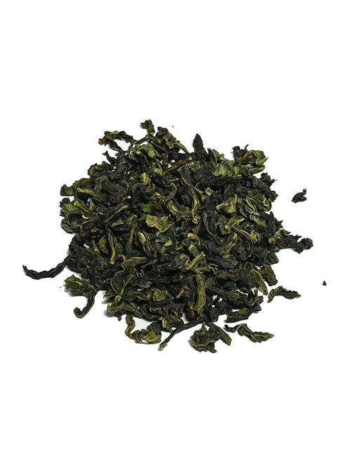 A small pile of Iron goddess of mercy Oolong loose-leaf green tea leaves on a plain white background.